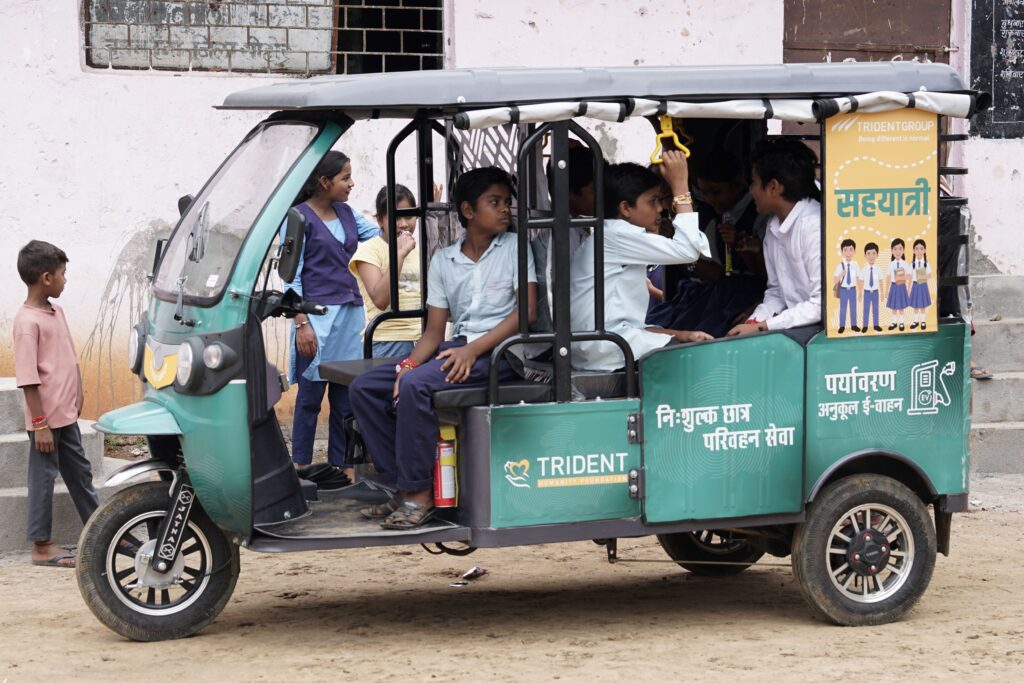 Budhni, Madhya Pradesh 7 Sept 2026

Reinforcing its commitment to community development and inclusive education, Trident Group, through the Trident Humanity Foundation, has introduced an E-Rickshaw service to provide free transportation for school-going children from the nearby communities of Gwardia, Patalkho, and Mahukala. The initiative has been implemented under the Foundation’s Village Adoption Programme, which focuses on rural development and Shiksha Protsahan (education promotion) through village transformation.

The initiative benefits 122 students from Classes 1 to 10 studying at Government High School, Patalkho, Budhni, by providing a free pick-up and drop facility for children commuting from Gwardia village and nearby colony areas.

A survey conducted by the Foundation revealed that students were required to walk long distances to reach school, with the challenge becoming particularly severe during the rainy season. This significantly affected regular school attendance and access to education.

To address this issue, Trident Group introduced a dedicated E-Rickshaw service that ensures safe, reliable, and convenient transportation for students. The service operates in accordance with school timings, enabling uninterrupted access to education.

Through this initiative, Trident Humanity Foundation continues to create meaningful social impact by removing barriers to education, promoting regular school attendance, and supporting the holistic development and well-being of children and communities. The initiative further advances the Foundation’s vision of rural development, community empowerment, and educational advancement under its Village Adoption Programme.